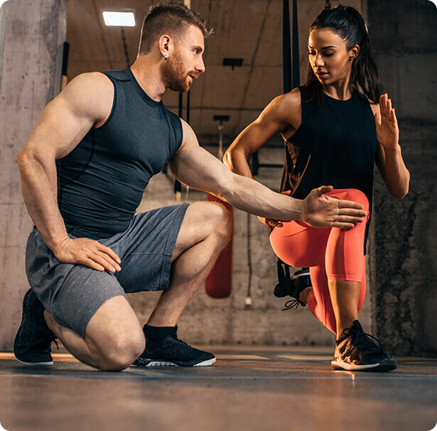 Personal trainer assisting member with strength and fitness training at Ogunquit Fitness Center