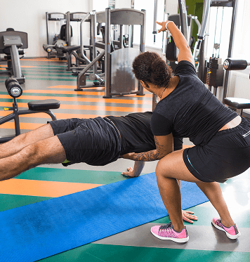 Members performing functional fitness and cardio training exercises at Ogunquit Fitness Center